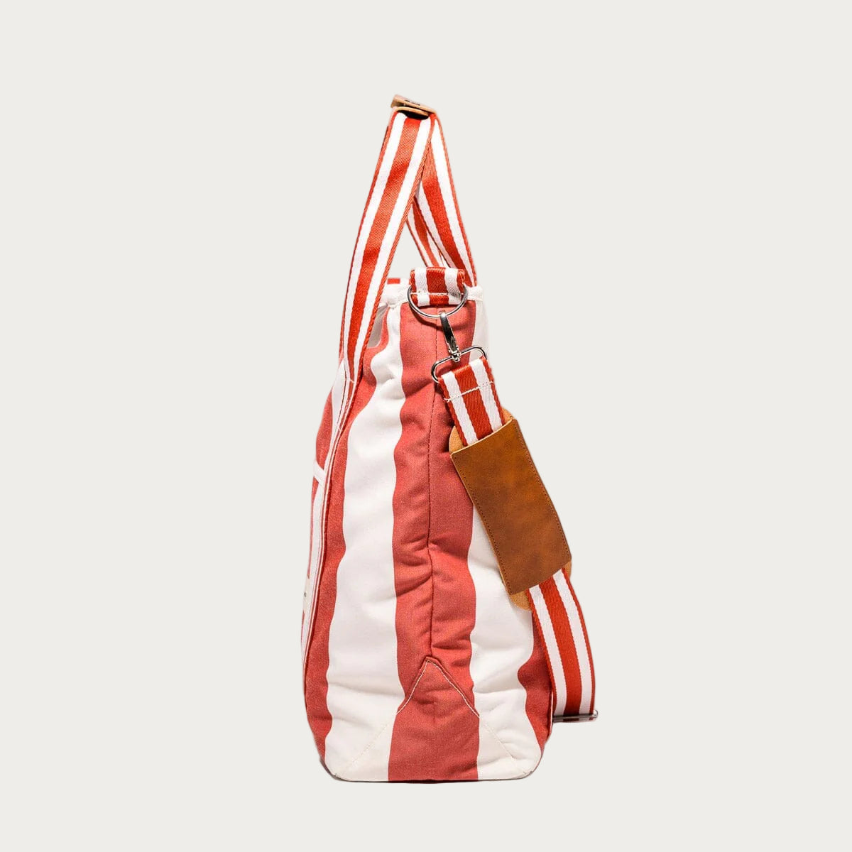 Red and white striped bag with a brown leather tag on a white background