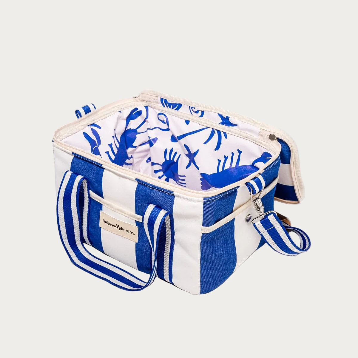 Blue and white striped cooler bag with a patterned top on a white background